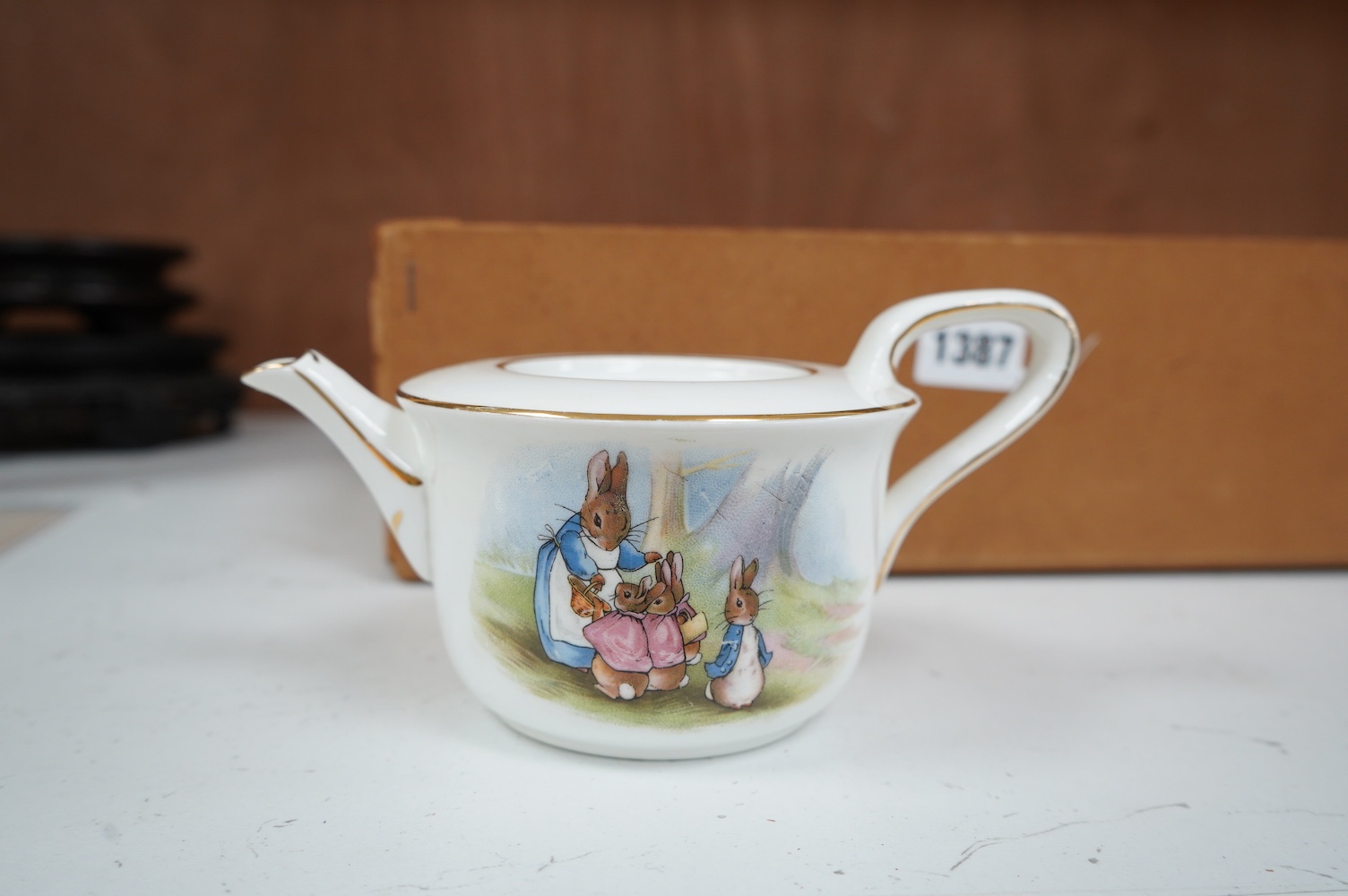 A children’s Beatrix Potter part tea set and other miniature porcelain tableware, largest 15.5cm wide. Condition - fair